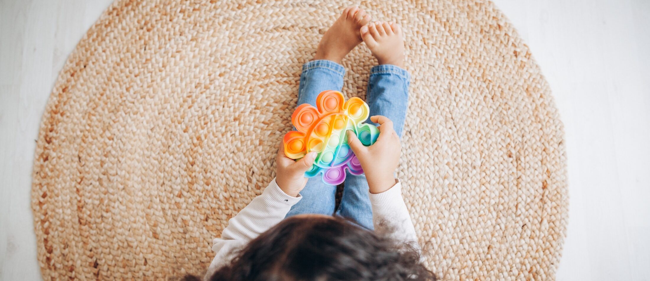 girl with autism playing with toy